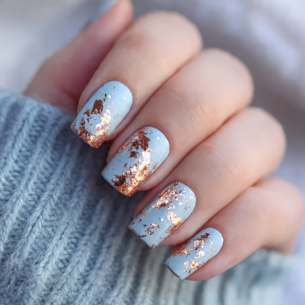 baby blue nails adorned with rose gold