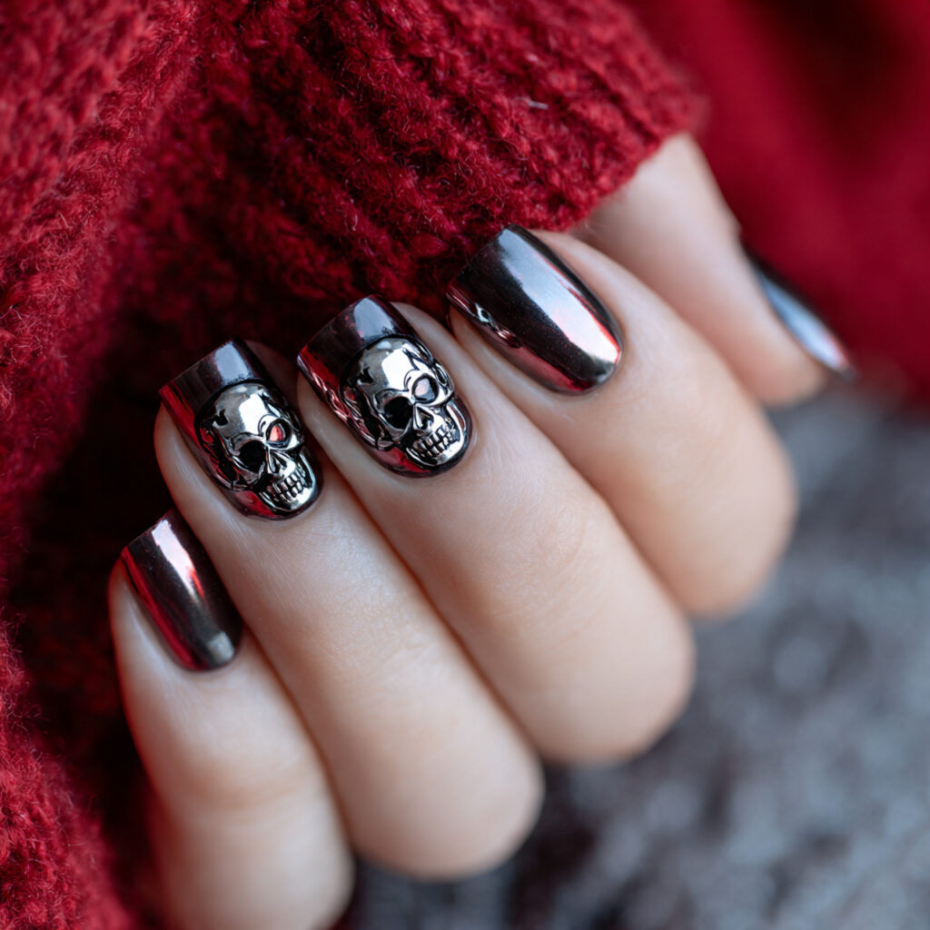 black chrome nails with skull embellishments or