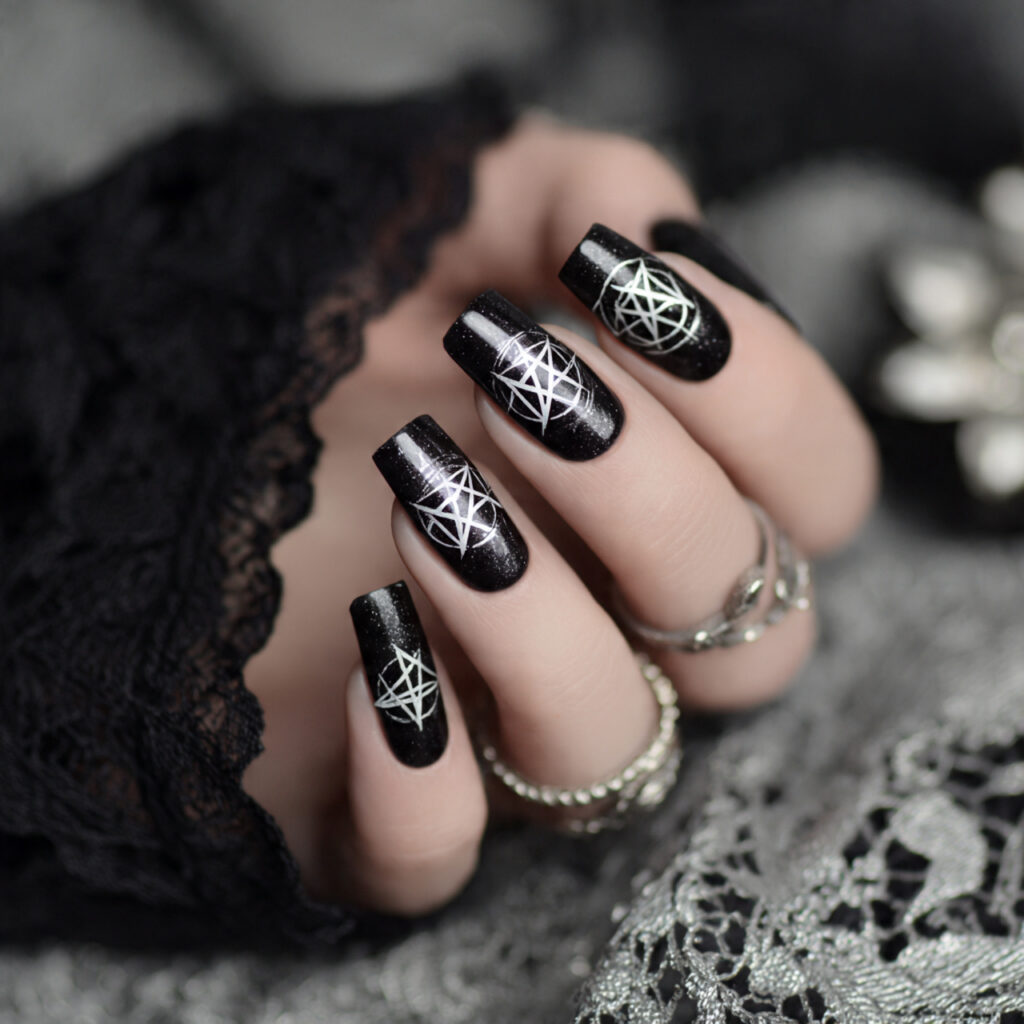 black nails adorned with white pentagram symbols