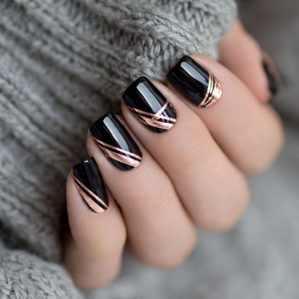 black nails with rose gold metallic stripes