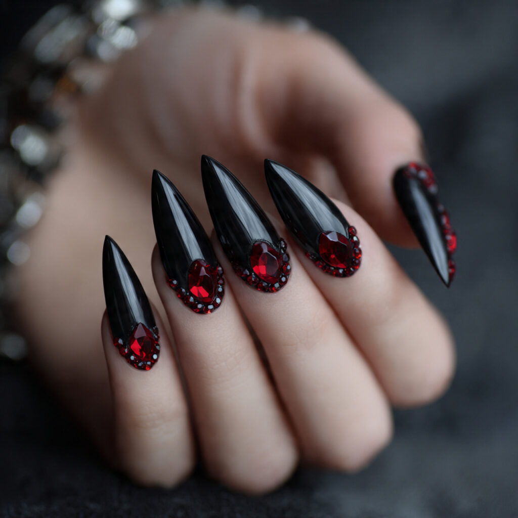 black stiletto nails with red gemstone effect tips