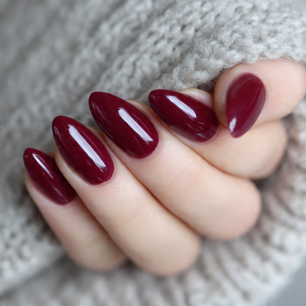 burgundy almond shaped nails with a glossy