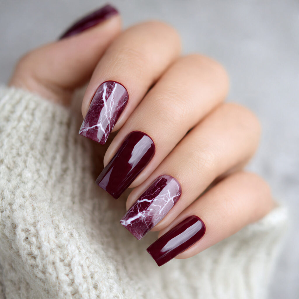burgundy nails with a marble effect feel