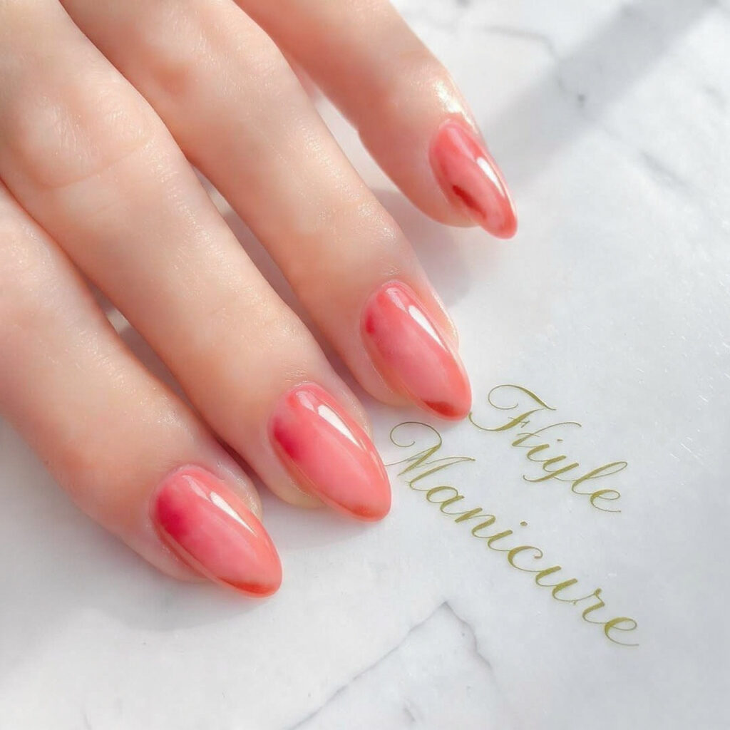 close up of glossy soft peach aesthetic nails