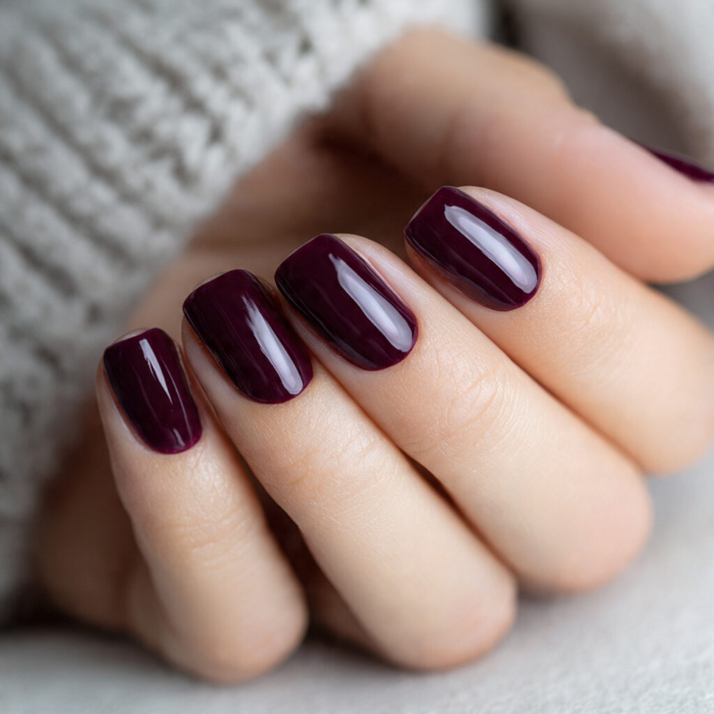 close up photo of deep plum colored nails