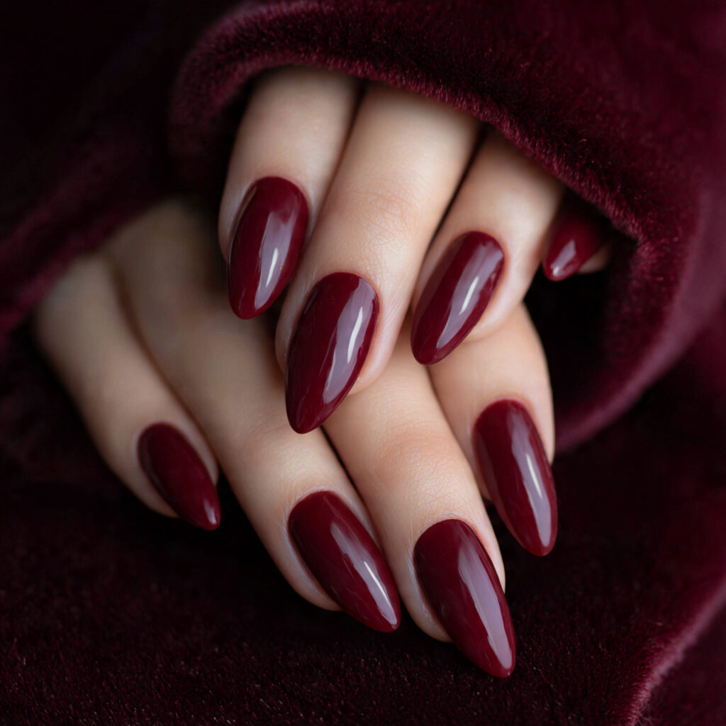 medium almond nails painted rich burgundy with hig
