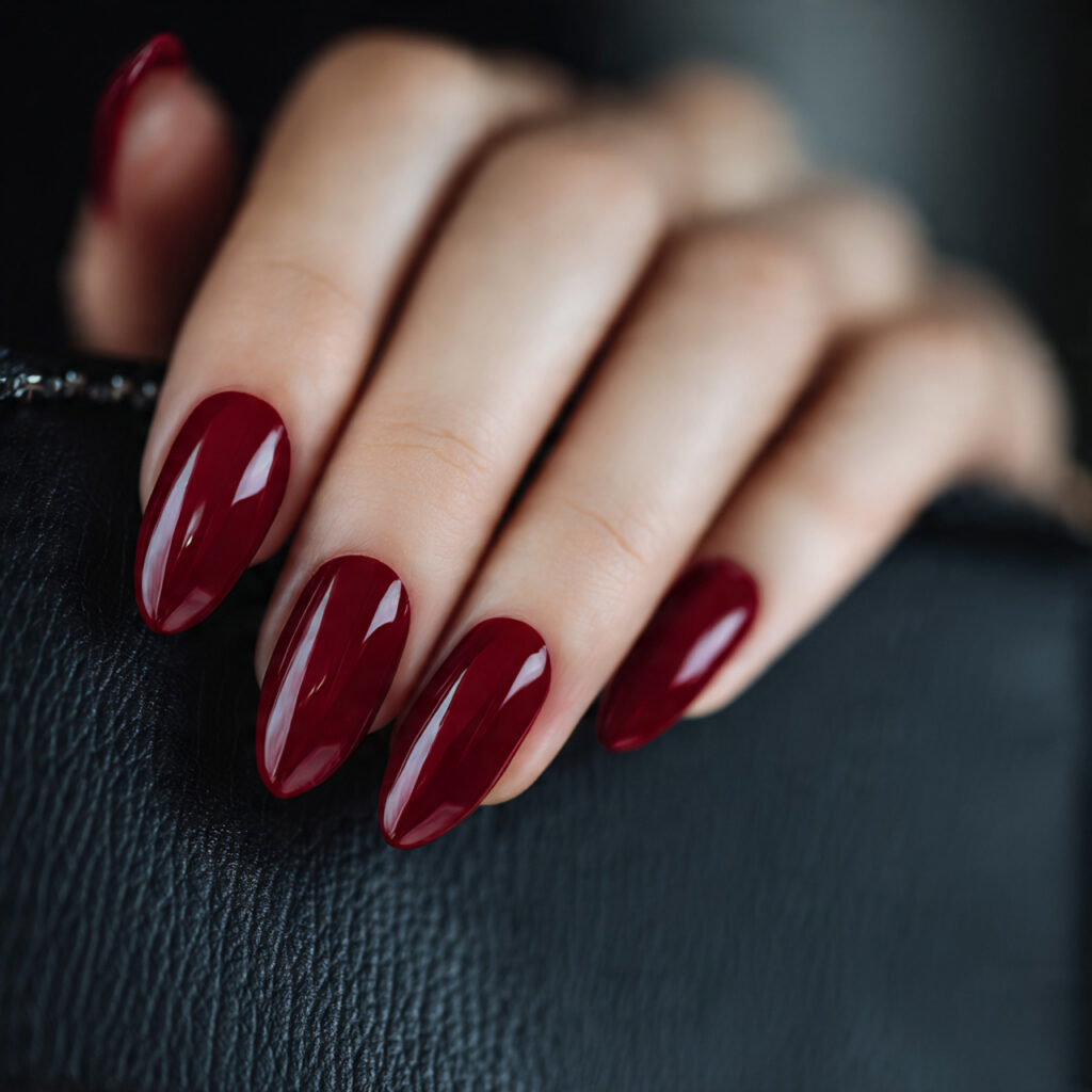 medium almond shaped nails painted in deep true re