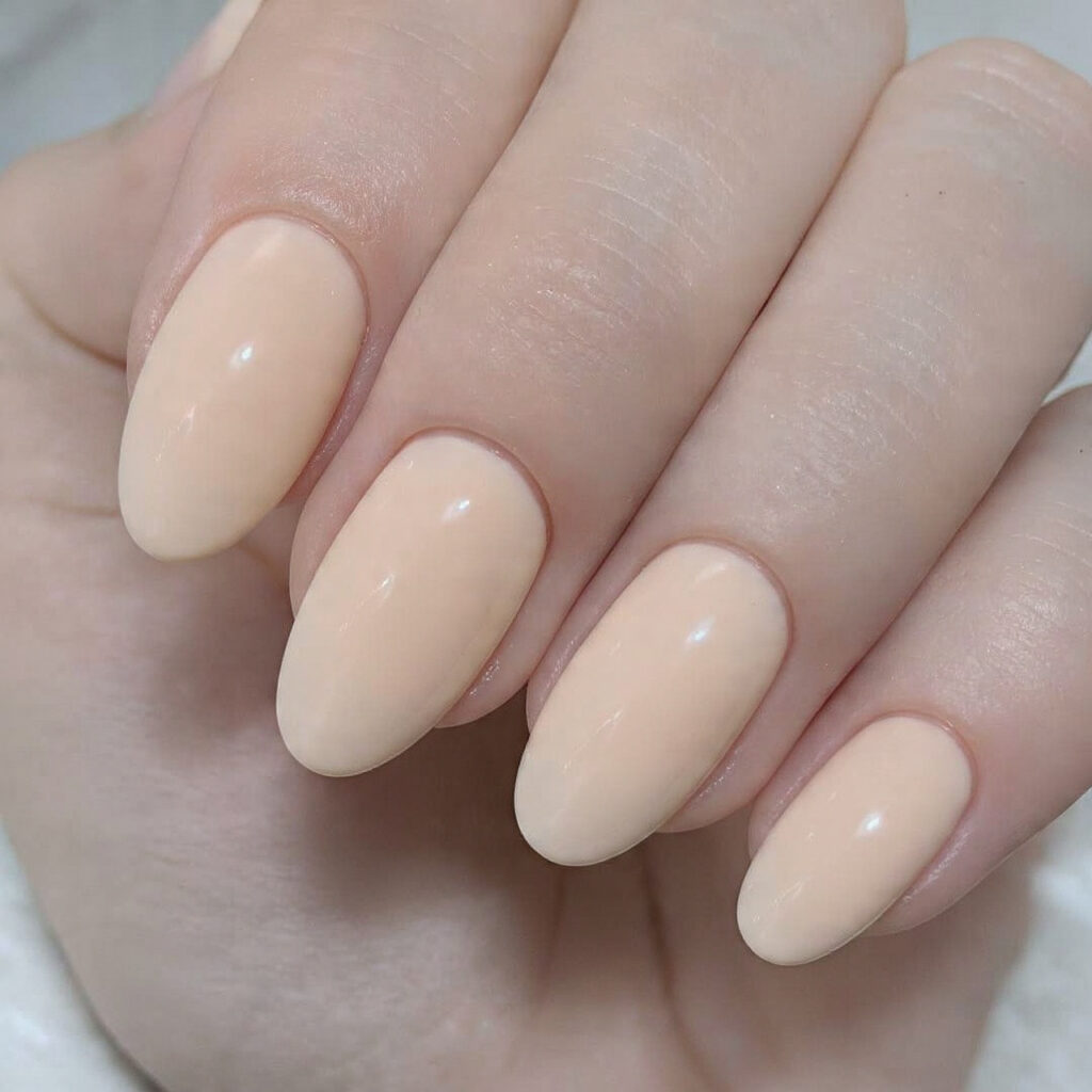 21 Simple Classy Nails 2026 That Look Clean and Elegant 19 warm creamy almond toned nails natural looking glossy finish